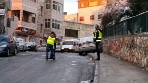Clearing snow and ice in Issawiya